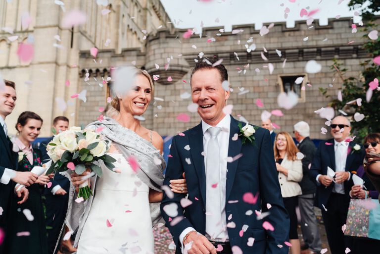 Candid Wedding photography captures the joyous moment perfectly, set against the backdrop of historic Norwich Castle. Norwich Wedding photography