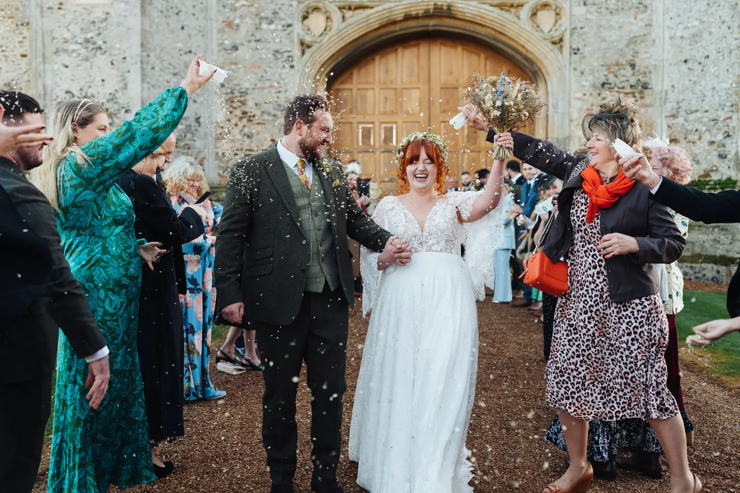 Megan and Sam with their wedding party in the grounds of Pentney Abbey Norfolk